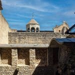 a stone wall with a building on top