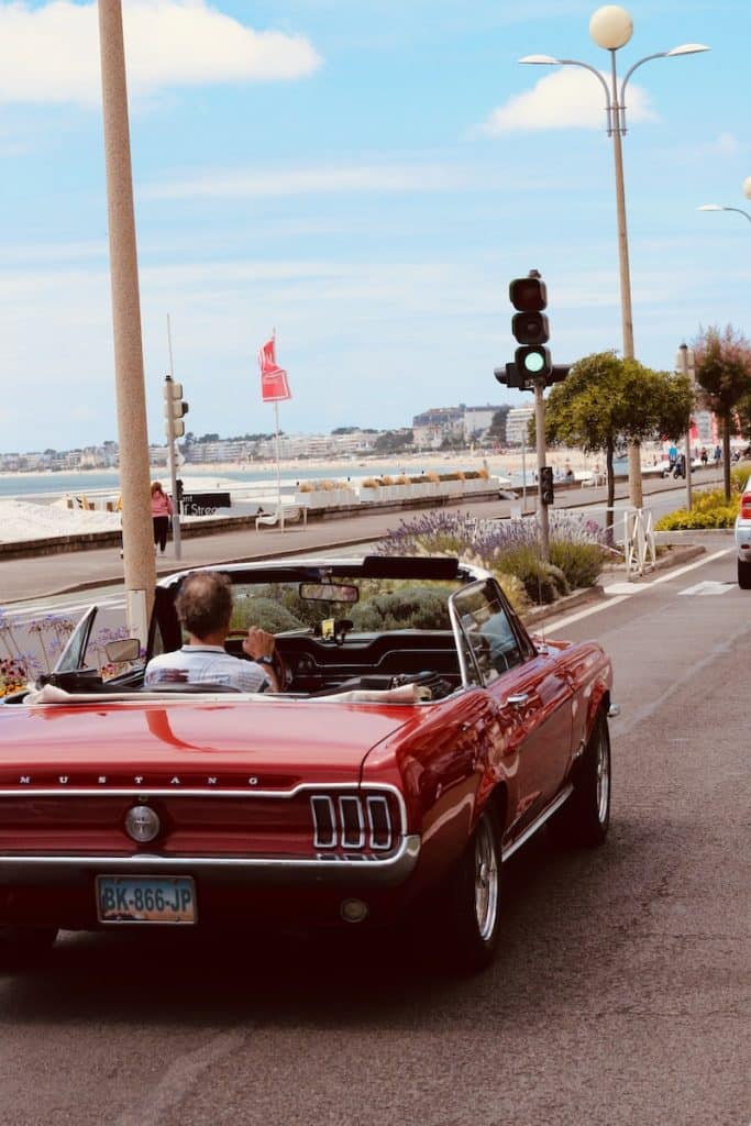 red convertible car on road during daytime